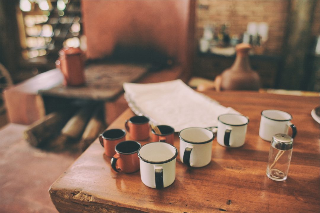 coffee cups on a table with work papers