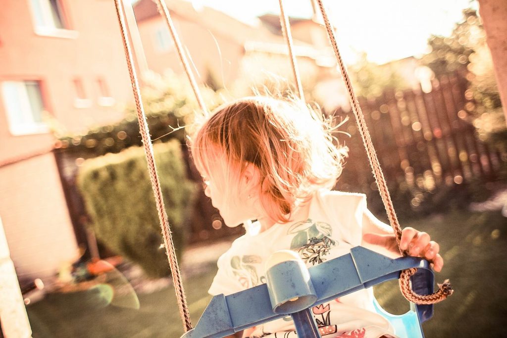 little girl on a swing