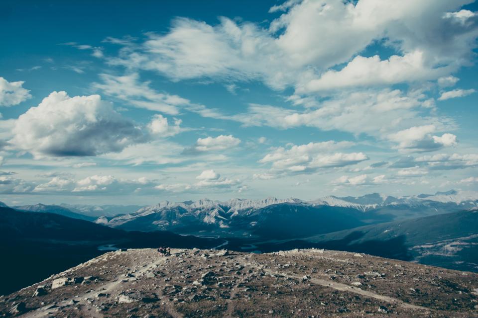 Beautiful blue sky with fluffy clouds and mountains in background